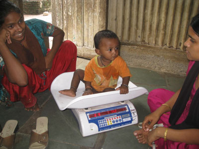 A baby being weighed at an Apnalaya community health check
