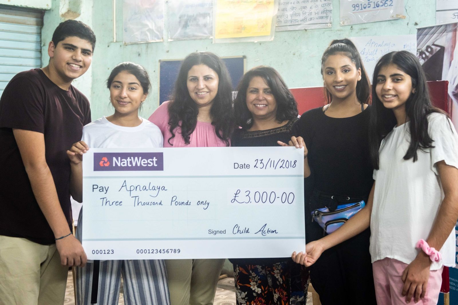 The youth ambassadors presenting a £3,000 cheque to Apnalaya