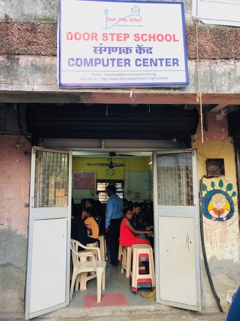 The entrance to the Door Step School Computer Center in Mumbai, with children working at computers inside