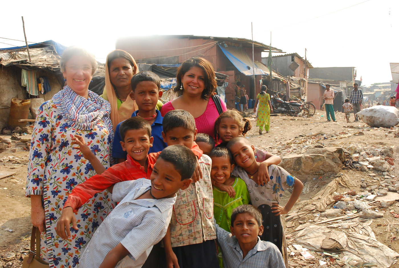 Founder Seema Sharma with children and partners in a Mumbai slum community