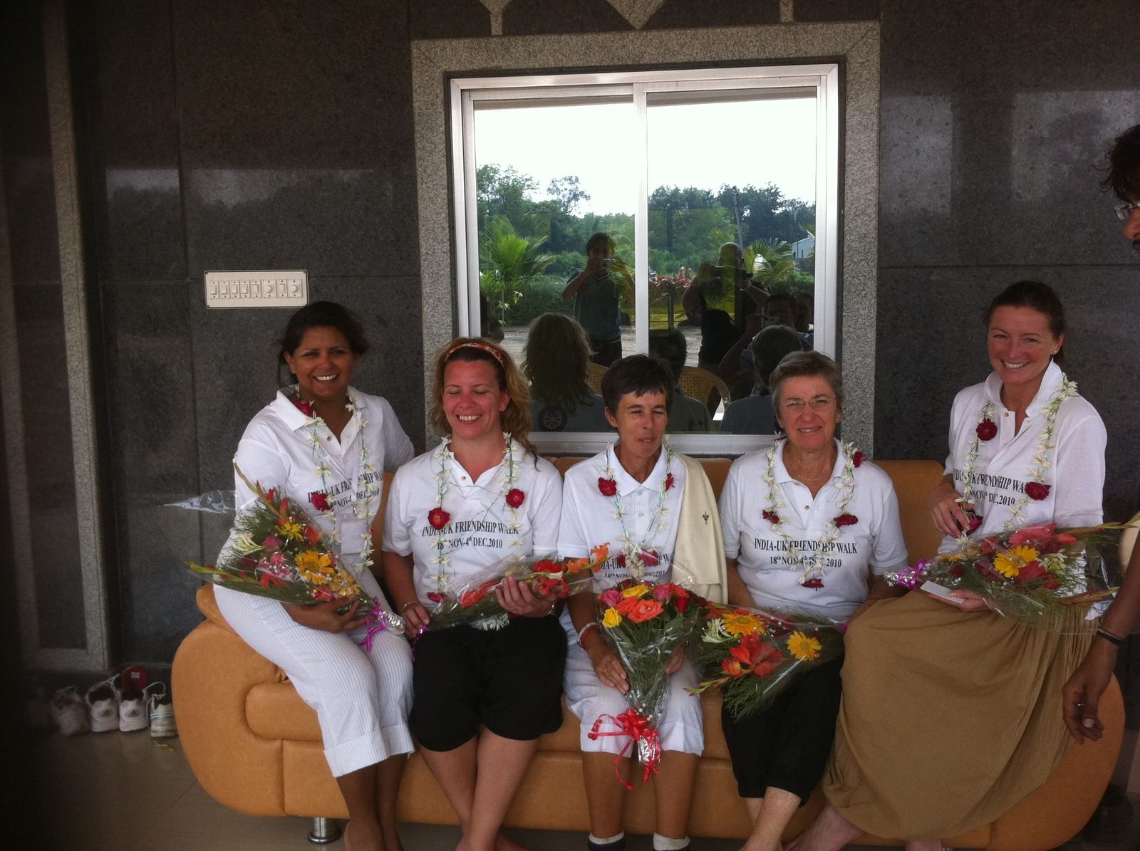 Five garlanded walkers with bouquets being welcomed at the end of the India-UK Friendship Walk