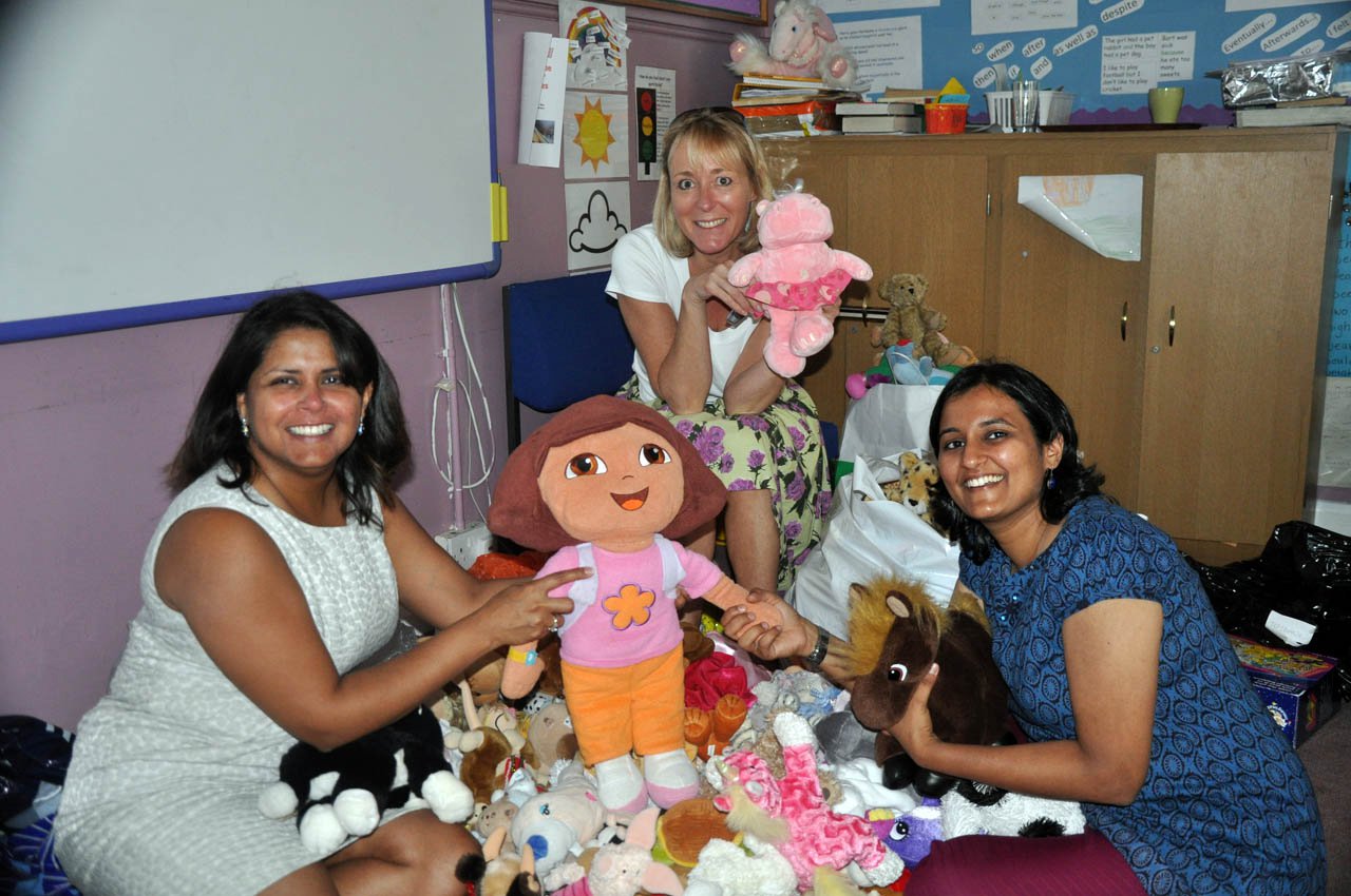 Volunteers sorting donated soft toys